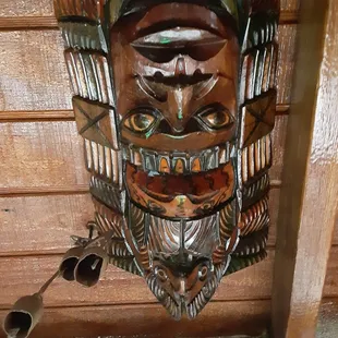 a wooden mask on the wall