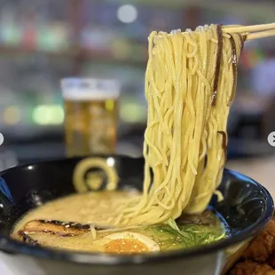 a bowl of ramen with chopsticks