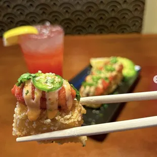chopsticks holding a piece of food