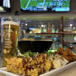 a plate of food and a glass of beer
