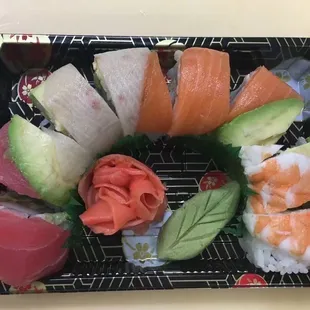 a sushi platter with salmon, avocado, and salmon