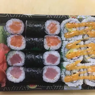 a plate of sushi and rolls