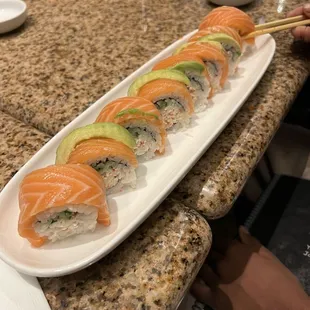 a sushi platter with salmon, avocado, and avocado