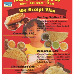 a child holding a hot dog