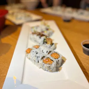 a plate of sushi rolls