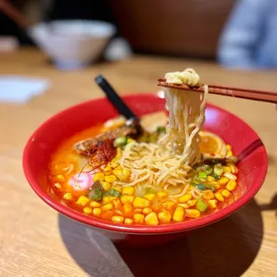 a bowl of ramen with chopsticks