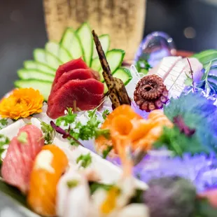 a plate of sushi and vegetables