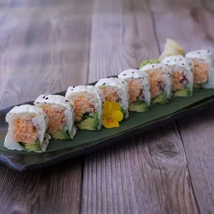 a sushi roll with salmon and avocado