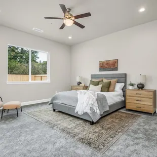 a bedroom with a ceiling fan