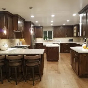 a kitchen with a center island and bar stools