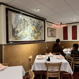 people sitting at tables in a restaurant