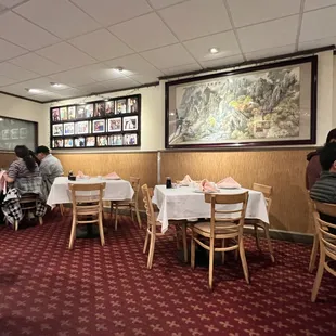 people sitting at tables in a restaurant