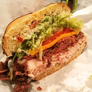 a roast beef sandwich with lettuce and tomato