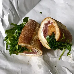 a sandwich cut in half on a piece of paper