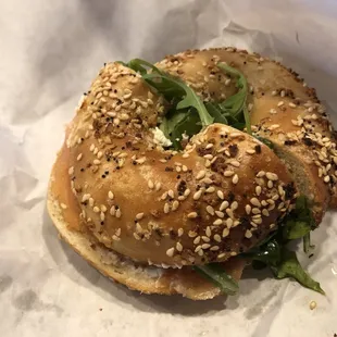 Lox bagel with cream cheese, capers, tomato, and arugula