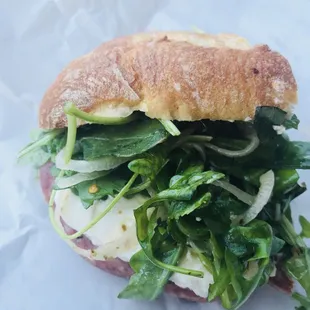 a close up of a sandwich with greens