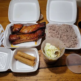Smoked pork Billy&apos;s, purple sticky rice, papaya salad, and two eggrolls.