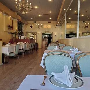 the interior of a restaurant with tables and chairs