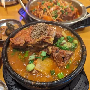 a bowl of soup with meat and vegetables