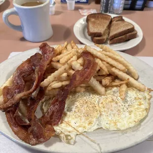 2 eggs, crinkle cuts, grilled bacon, and wheat toast