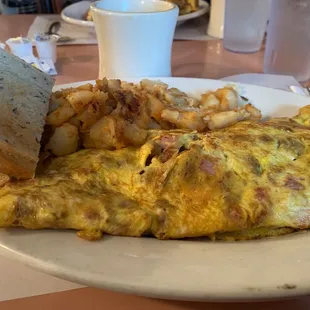 an omelet with potatoes and a sandwich
