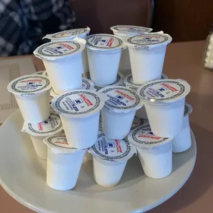 a stack of yogurt cups on a plate
