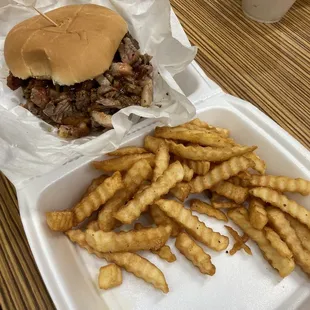 Brisket sandwich with fries.