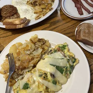 First dish- veggie omelette with home fries.  Second dish-egg breakfast, side of toast and a side of bacon.