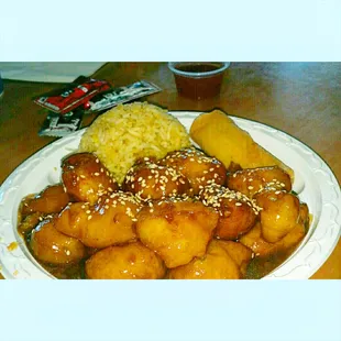 Sesame chicken and a scoop of fried rice.