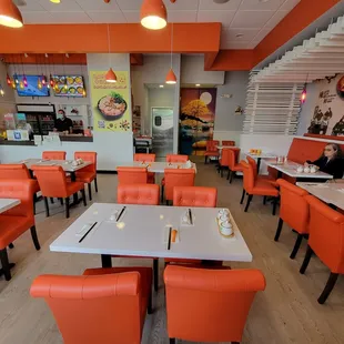 The dining room. The restrooms are on the right through the curtains. The kitchen door is to the left of the curtains.