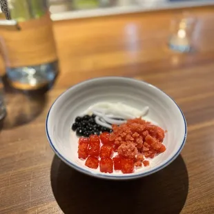 Milk pudding topped with brown sugar boba, young coconut strips, strawberry granita and jicama.