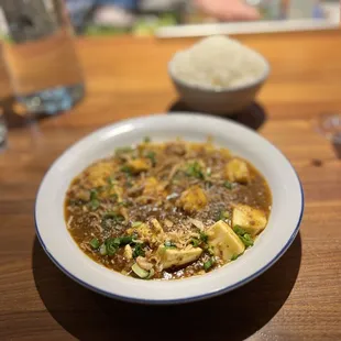 Signature mapo tofu made with egg custard &quot;tofu&quot; and ground beef and pork. Comes with white rice.