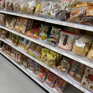 a variety of snacks on a supermarket shelf