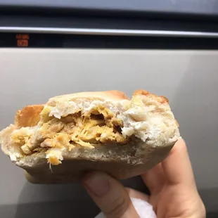 a hand holding a sandwich