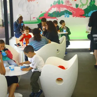 a group of children sitting at a table