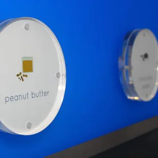 a blue wall with four different buttons