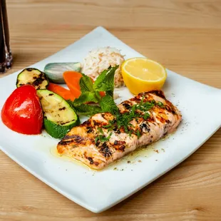 a plate of grilled fish and vegetables