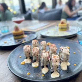 sushi rolls on a plate with sauce