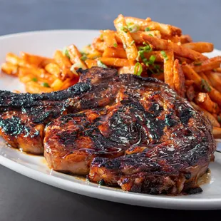 Our 20 oz bone-in ribeye, with a sweet soy ginger marinade and chili garlic fries with green onions, parmesan and crispy garlic.