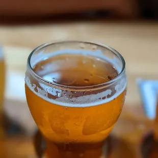 a glass of beer on a table