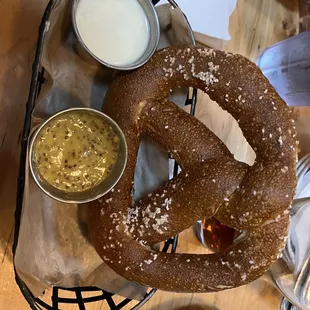 Soft pretzel with white cheddar dipping sauce and horseradish mustard dipping sauce