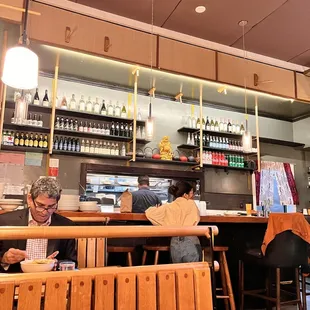 two people sitting at a bar