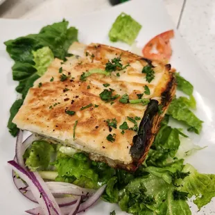 a grilled sandwich on a bed of lettuce