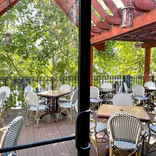 a patio with tables and chairs