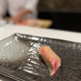 a sushi on a black plate