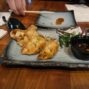 Gyoza, these are pork and vegetables dumplings and it comes with a side of chili soy sauce.