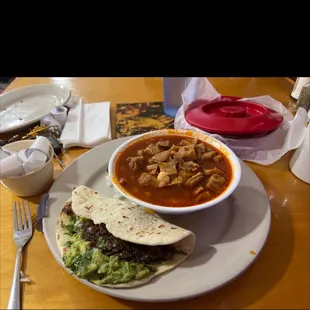 Small menudo  Barbecue  taco with guacamole small menudo with onions. Barbacoa taco  with guacamole, onions and cilantro. Tortillas