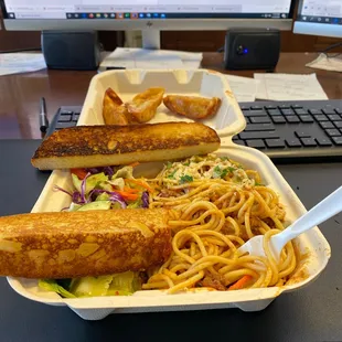 a take out container of noodles and tofu