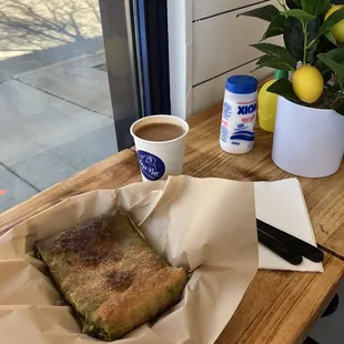 Traditional spinach and feta cheese pie slice and Greek coffee