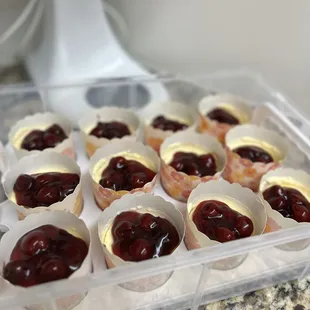 a tray of jelly filled cupcakes